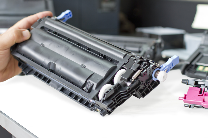 toner cartridge recycling - man holding toner cartridge