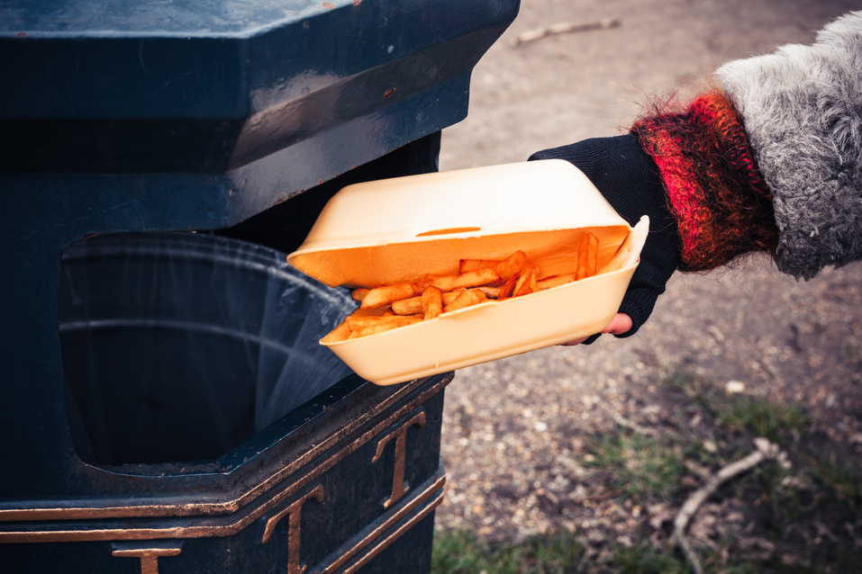 chips being thrown in the bin - fast food waste and recycling